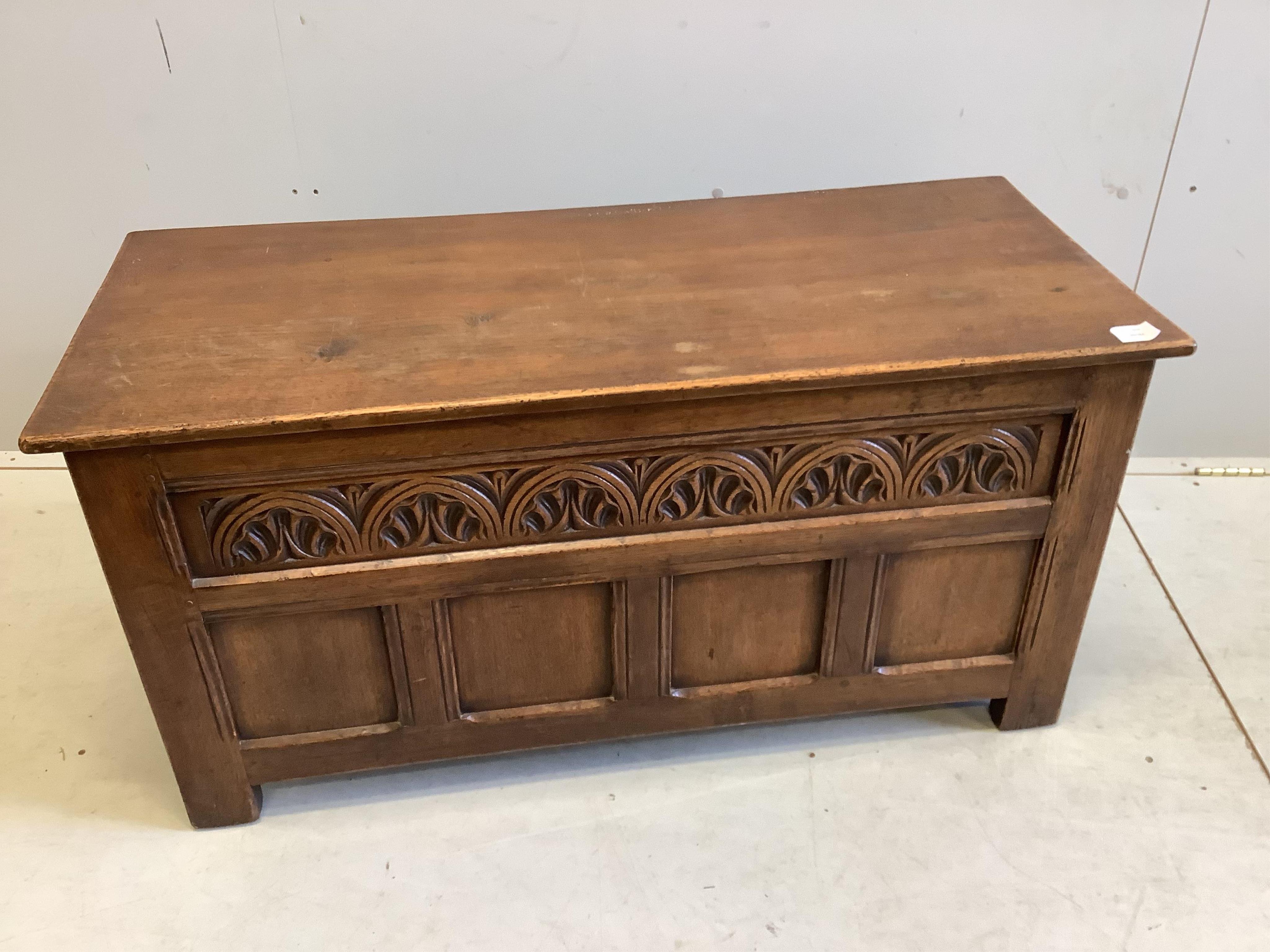 A reproduction 18th century style carved oak coffer, width 106cm, depth 46cm, height 54cm together with an elm and beech Windsor elbow chair. Condition - fair
